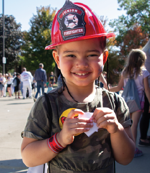 Young boy wearing fireman's helmet