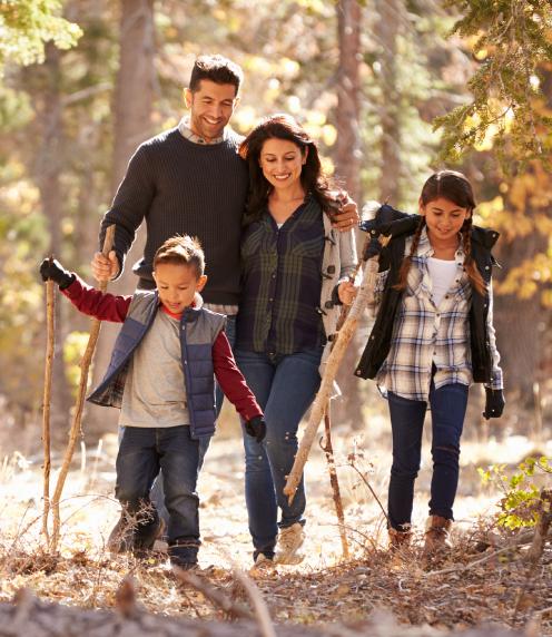 Image: Family on a hike smiling and having a good time.