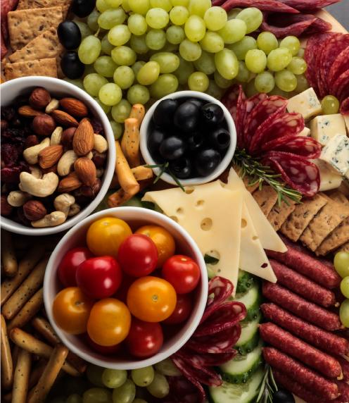 Charcuterie board with various meats, fruits, and nuts