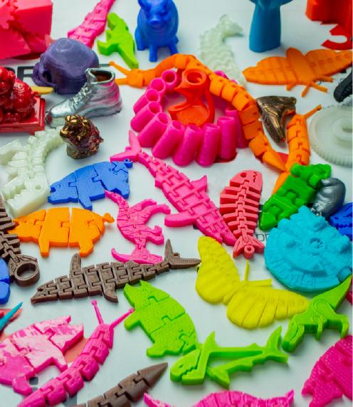 A variety of colorful toys and trinkets that have been 3d printed