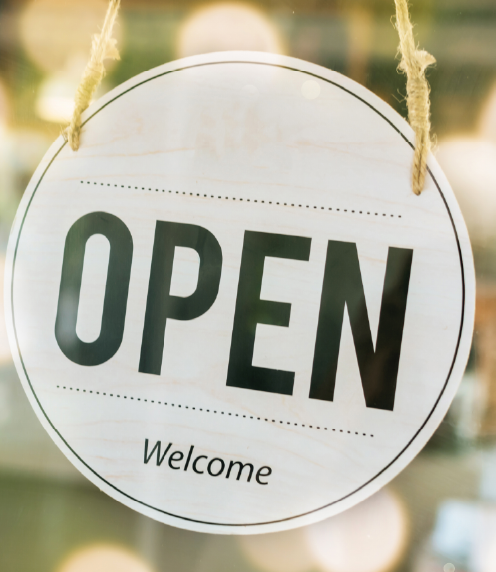 Close up of a circular open sign hanging in a window