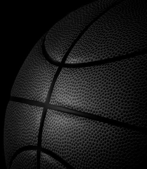 Black basketball fading into a black background