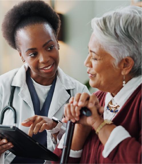 Elderly woman with her doctor, looking at a clipboard