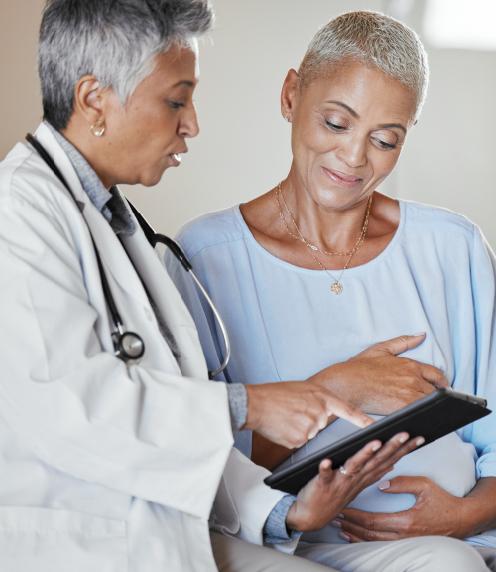 Mature woman and her doctor looking at information on a tablet
