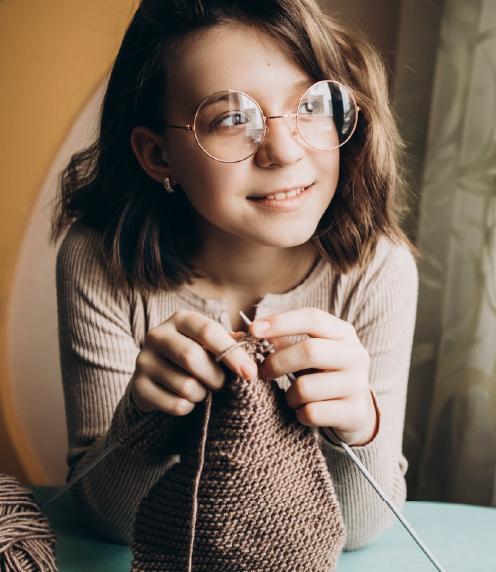 Teenager using knitting needles